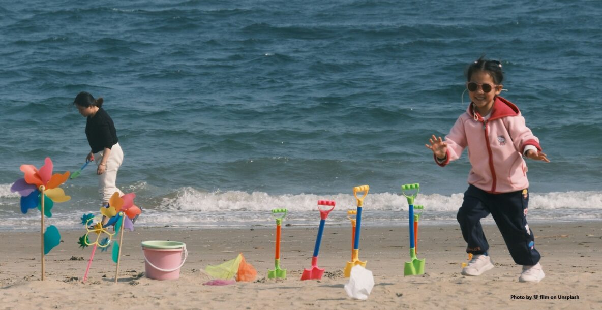 Child playing on a beach in summer